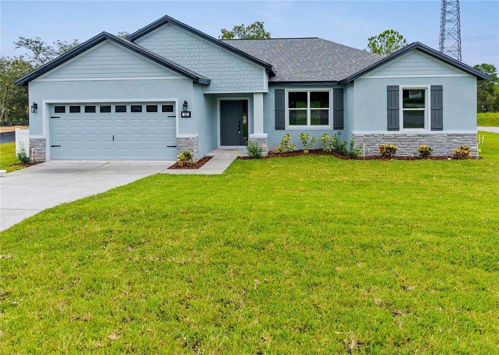 a front view of house with yard and green space