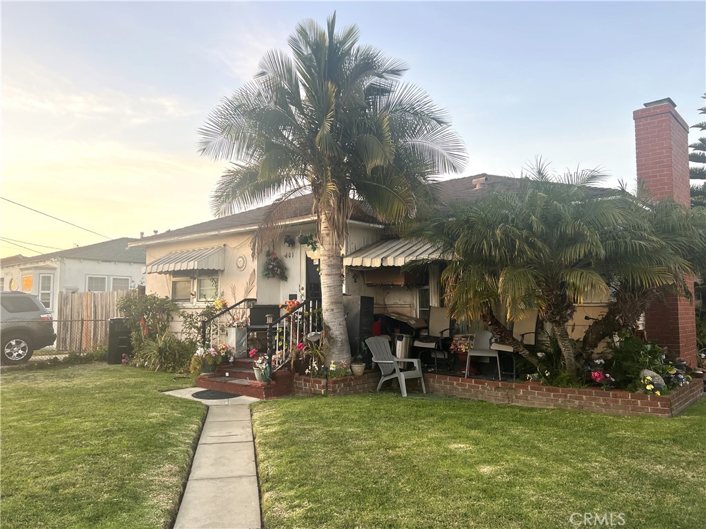 a view of a house with backyard porch and sitting area