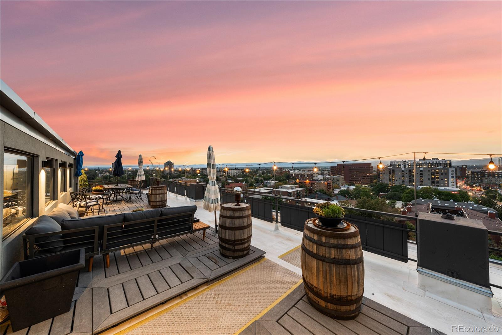 a view of roof deck with a barbeque and wooden stairs