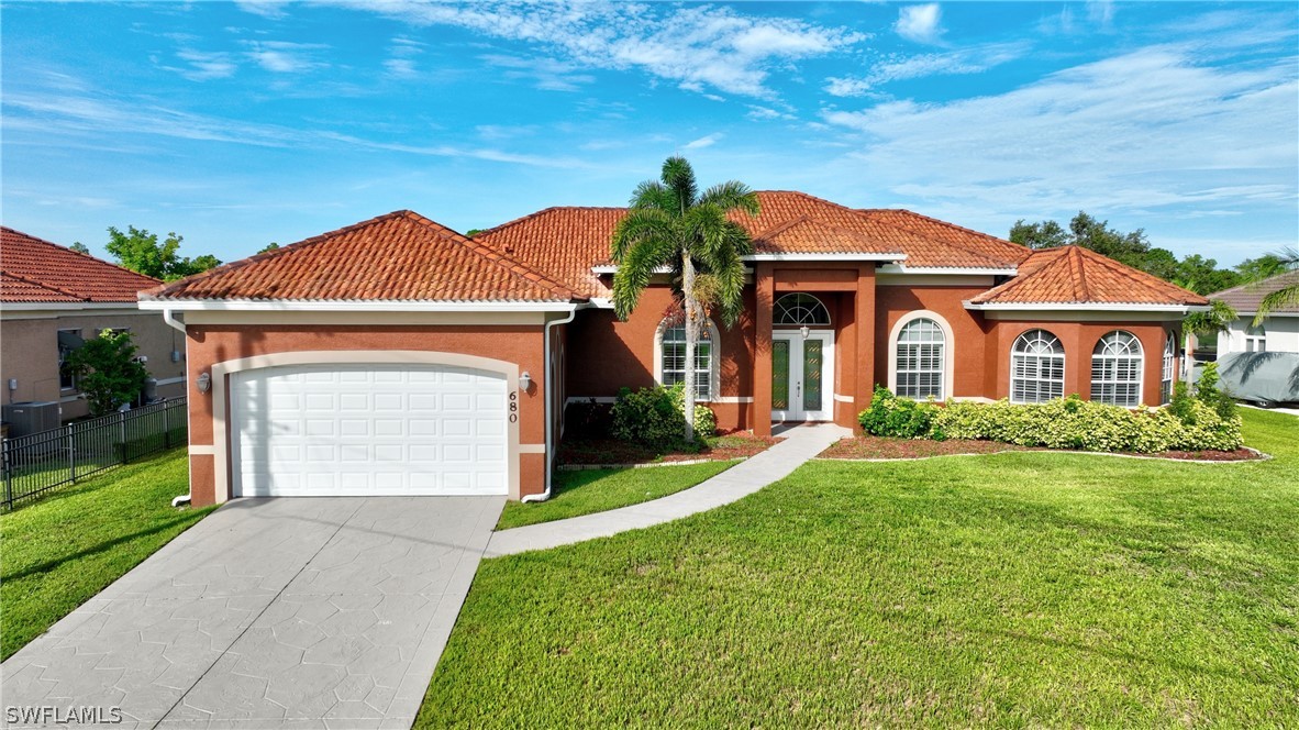 a front view of a house with a yard and garage