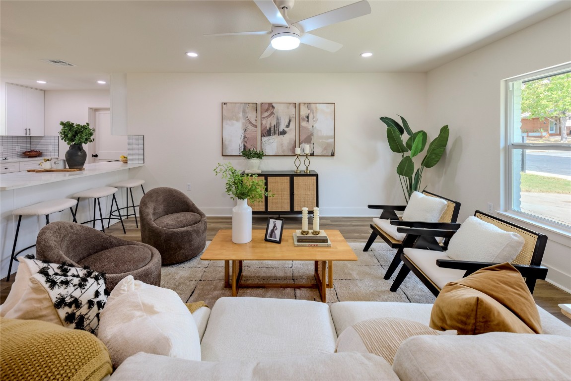 a living room with furniture and wooden floor