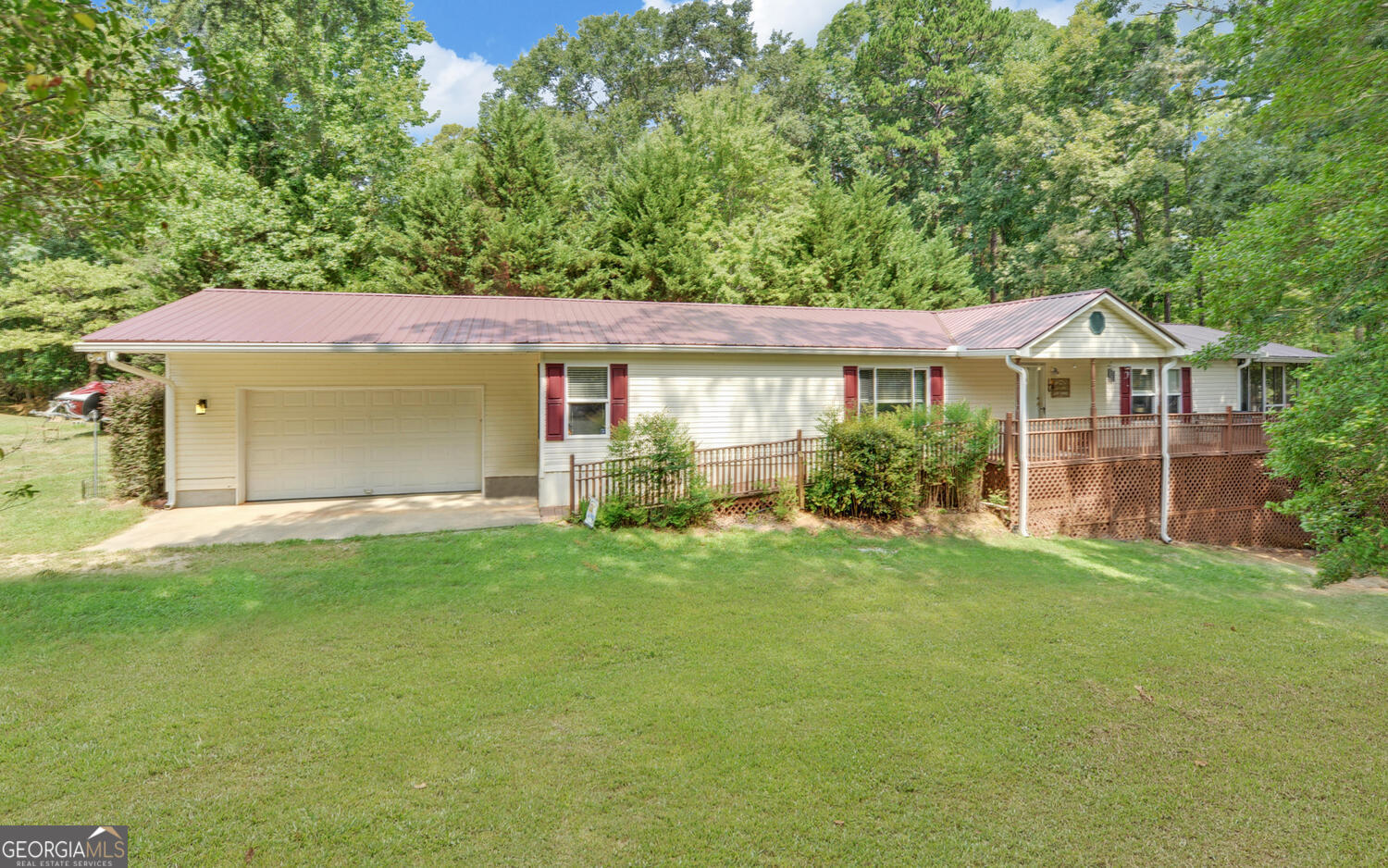 a front view of a house with a yard and green space