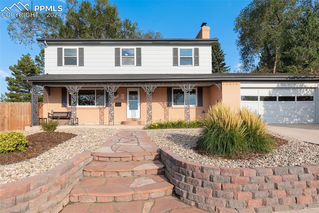 New retaining walls, xeriscaping and wide walkway with deep stairs.