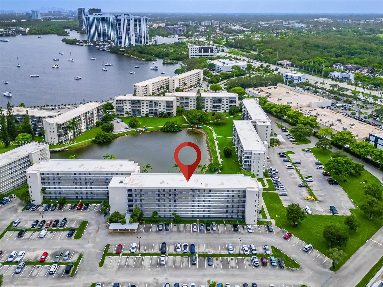 an aerial view of residential houses with outdoor space and parking