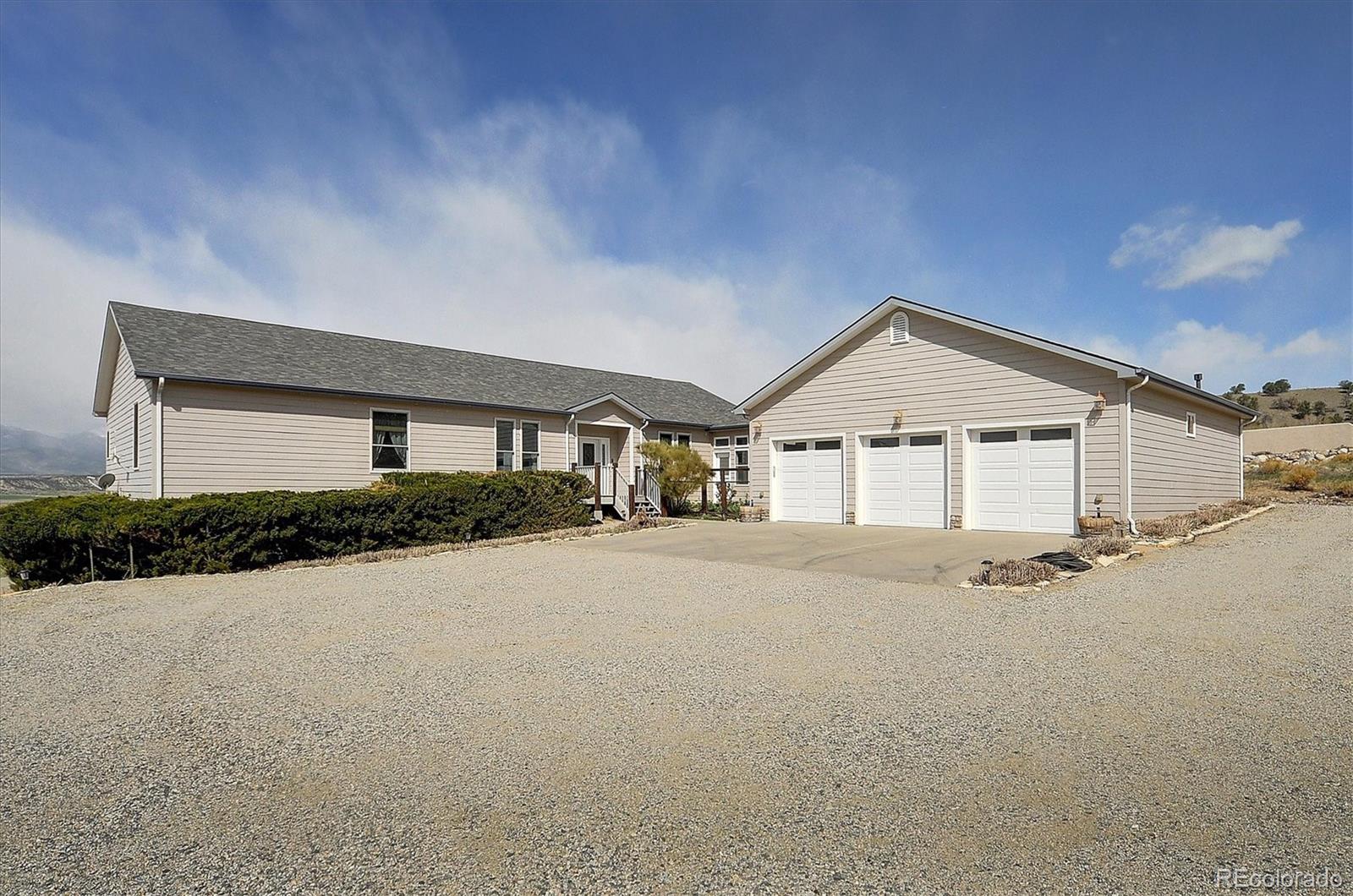 a view of house with yard and garage