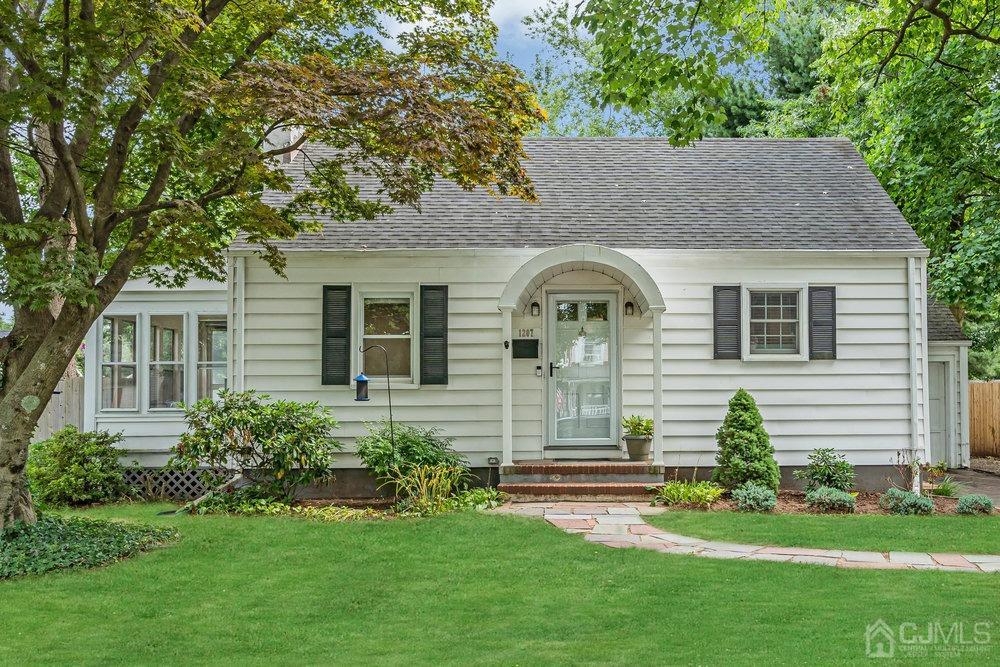 a front view of a house with a garden