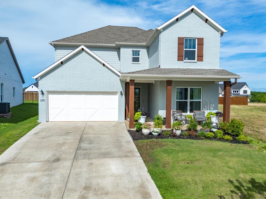 a front view of a house with a yard and porch