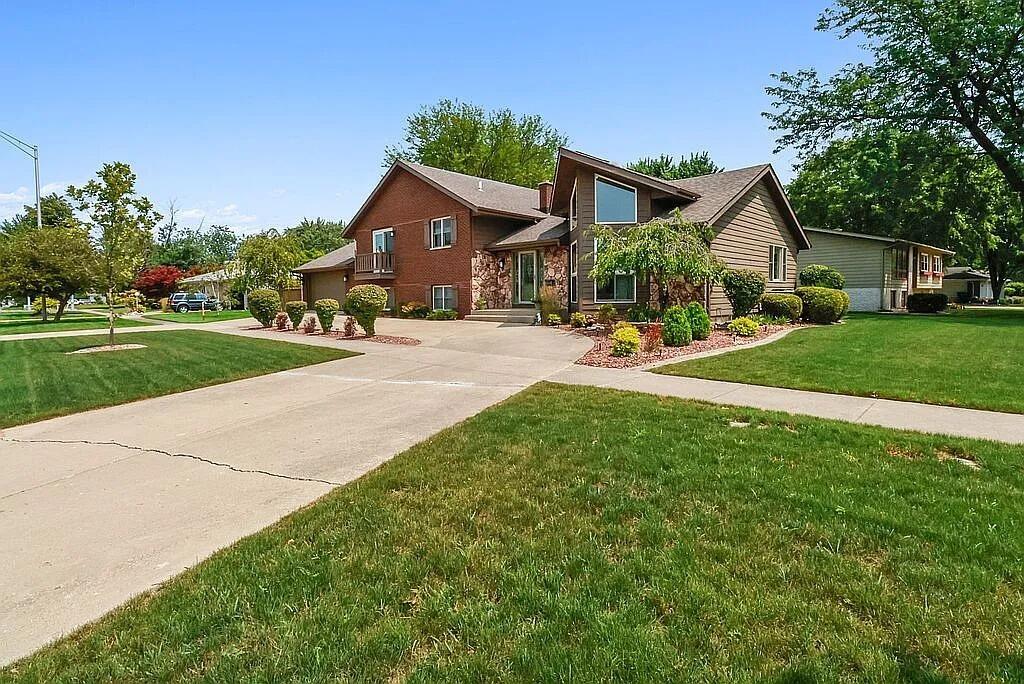 a front view of house with yard and green space