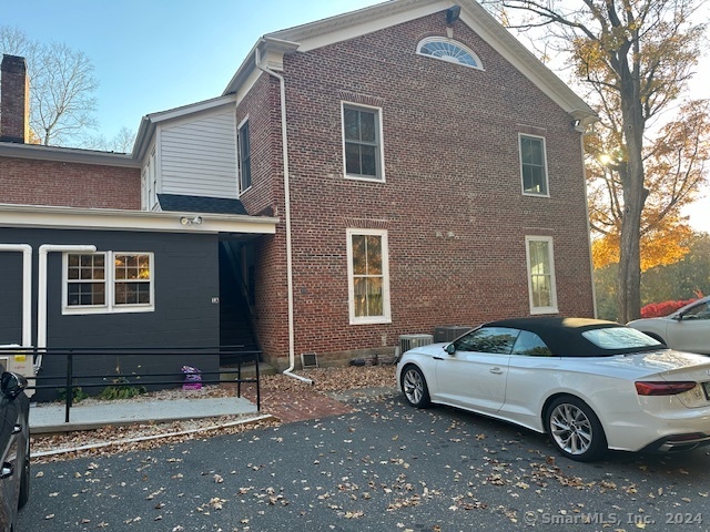 a front view of a house with parking space