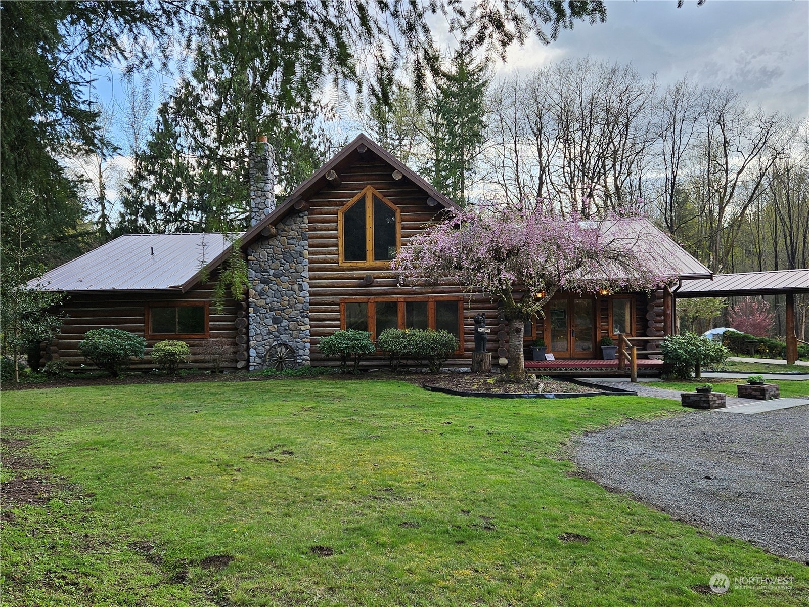 a view of a house with garden and sitting area