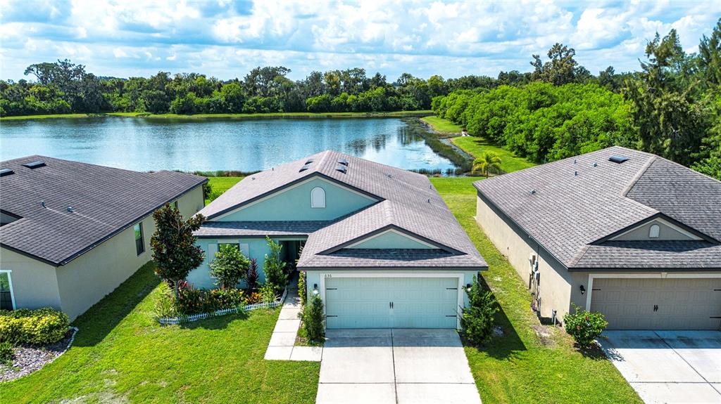 an aerial view of house with garden space and lake view