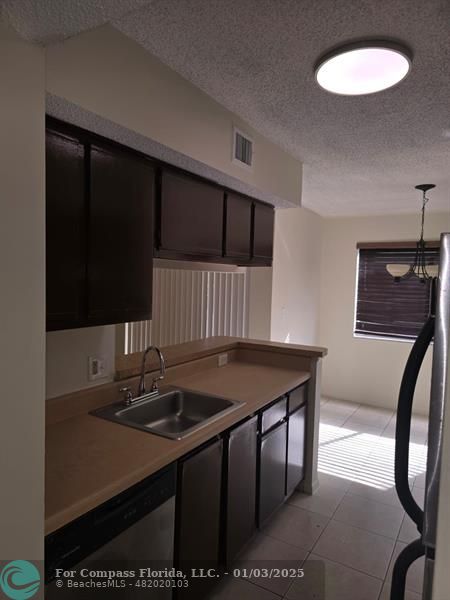 a kitchen with a table chairs and a refrigerator