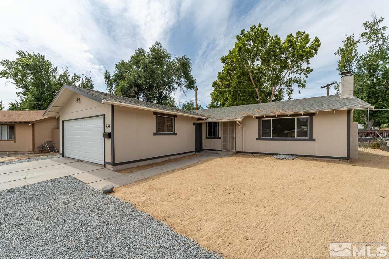 a view of a house with a backyard and garage