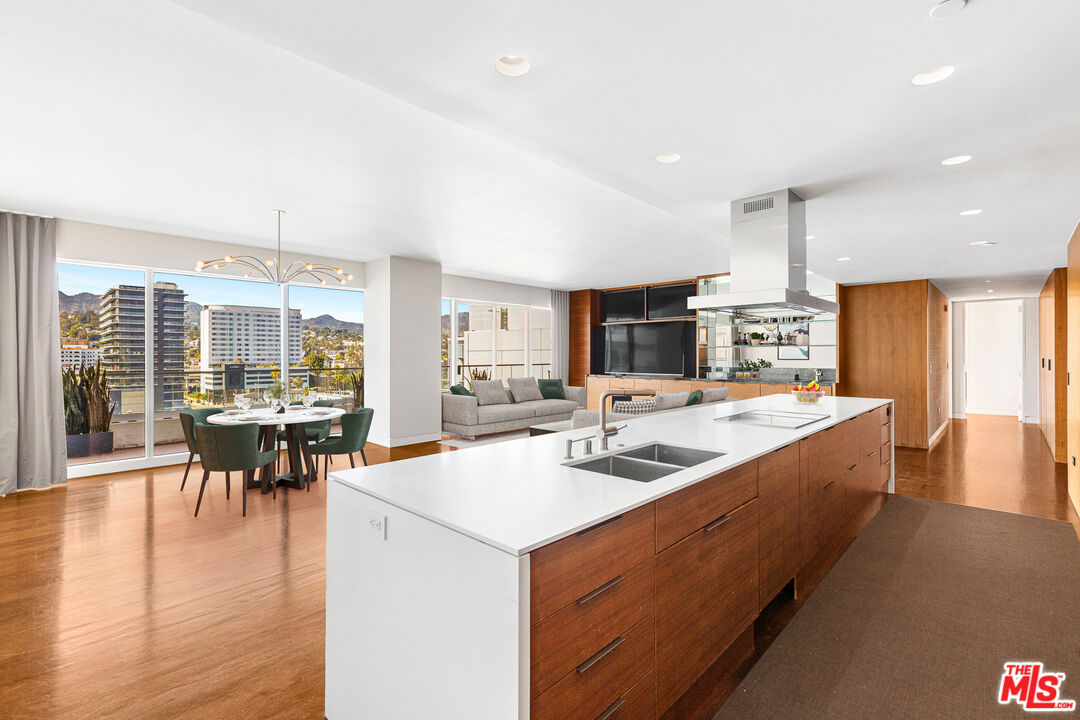 a large kitchen with kitchen island a sink table and chairs