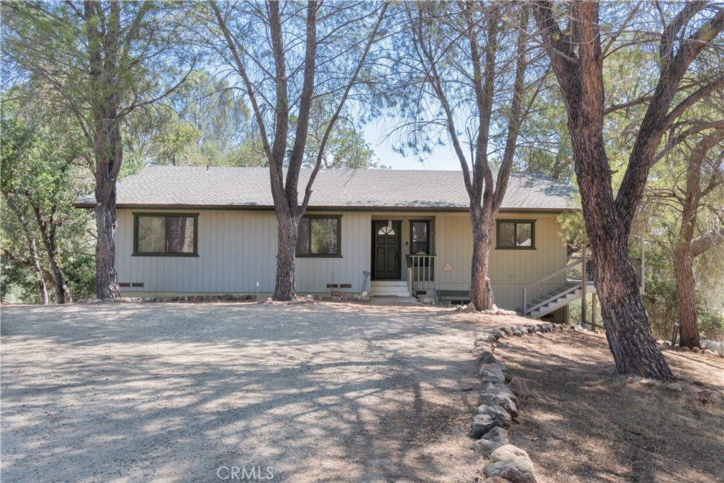 a front view of a house with a trees