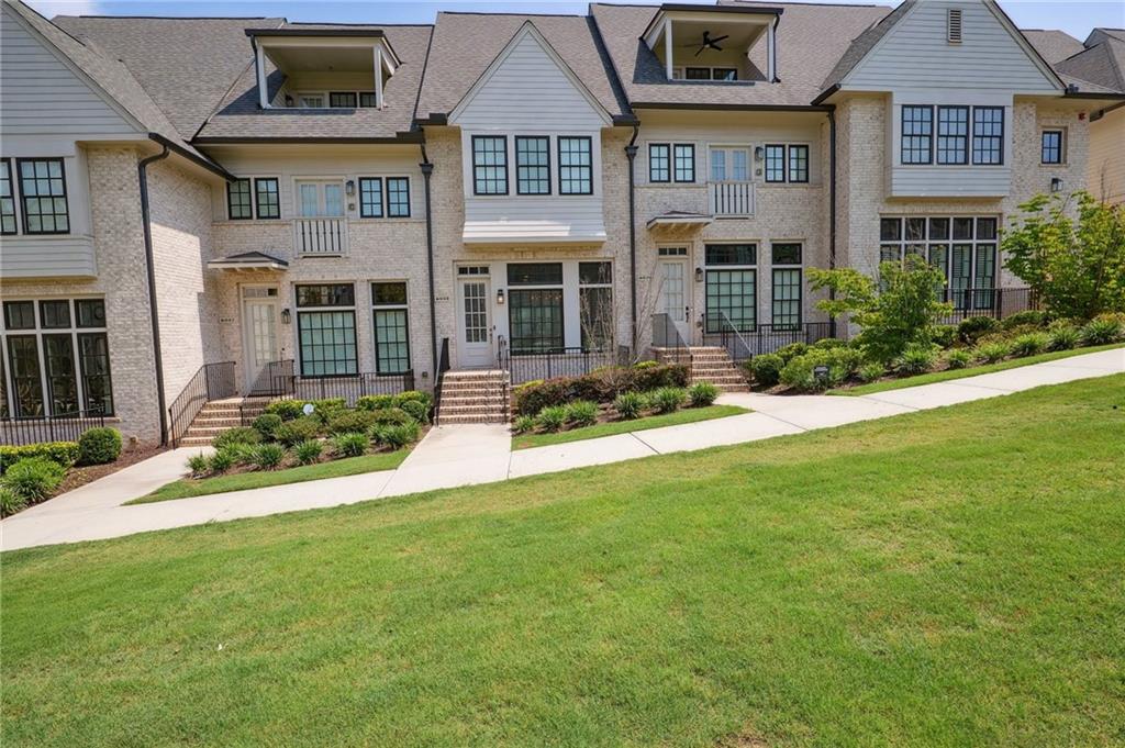 front view of a brick house with a yard