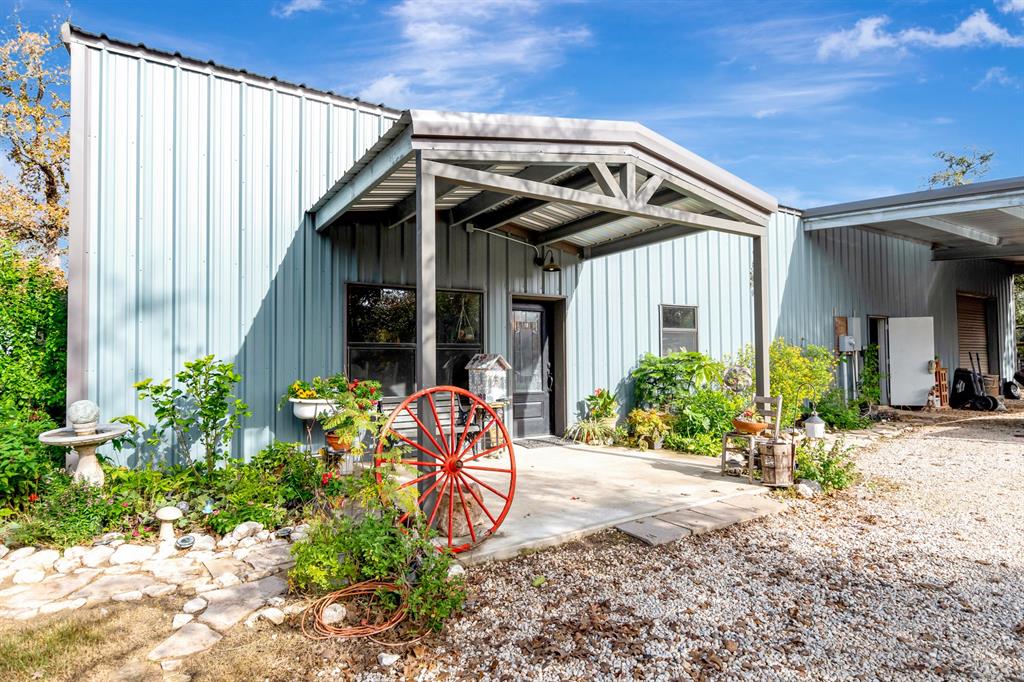 a front view of a house with a yard and potted plants