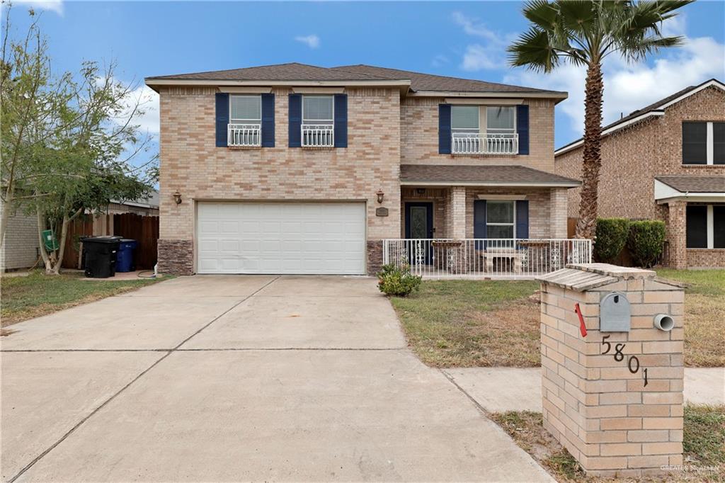 View of front of home with a porch and a garage