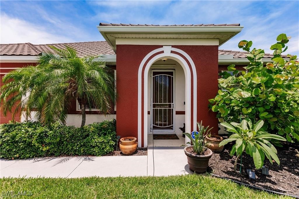 a front view of a house with plants