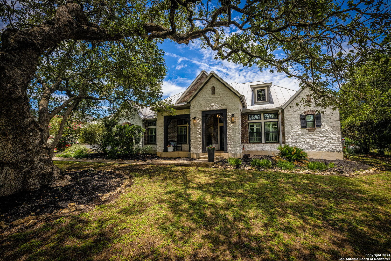 a front view of a house with a garden