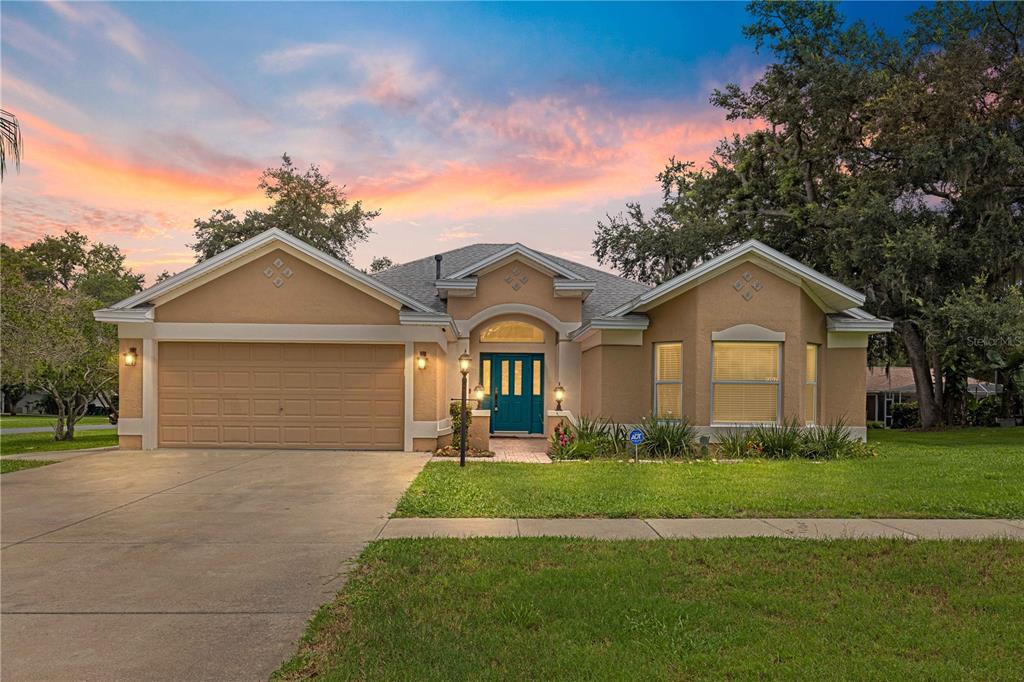 a front view of a house with a yard and garage