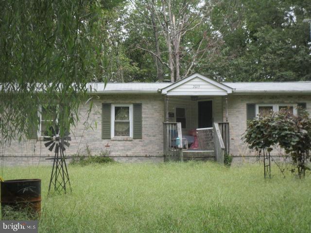 a front view of house with a garden