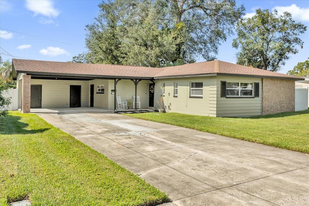 a view of a house with a backyard