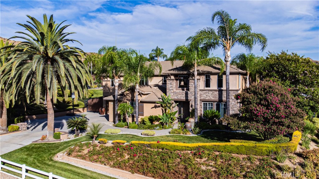 a view of a house with swimming pool and a yard