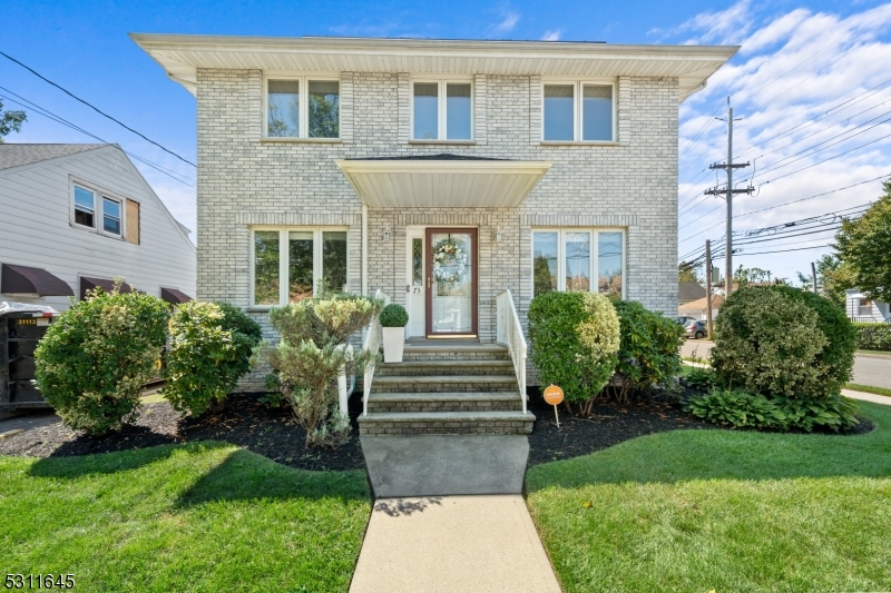 a front view of a house with garden