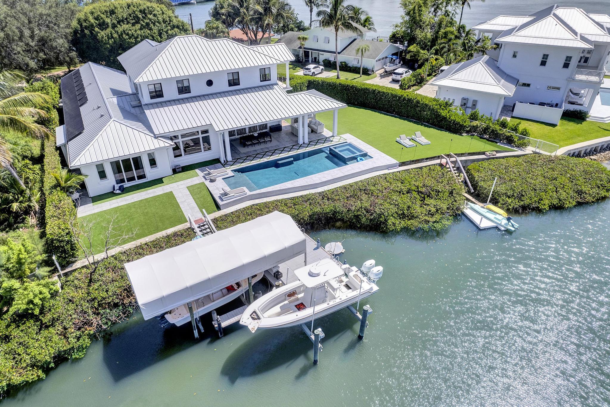 an aerial view of a house with a yard and swimming pool