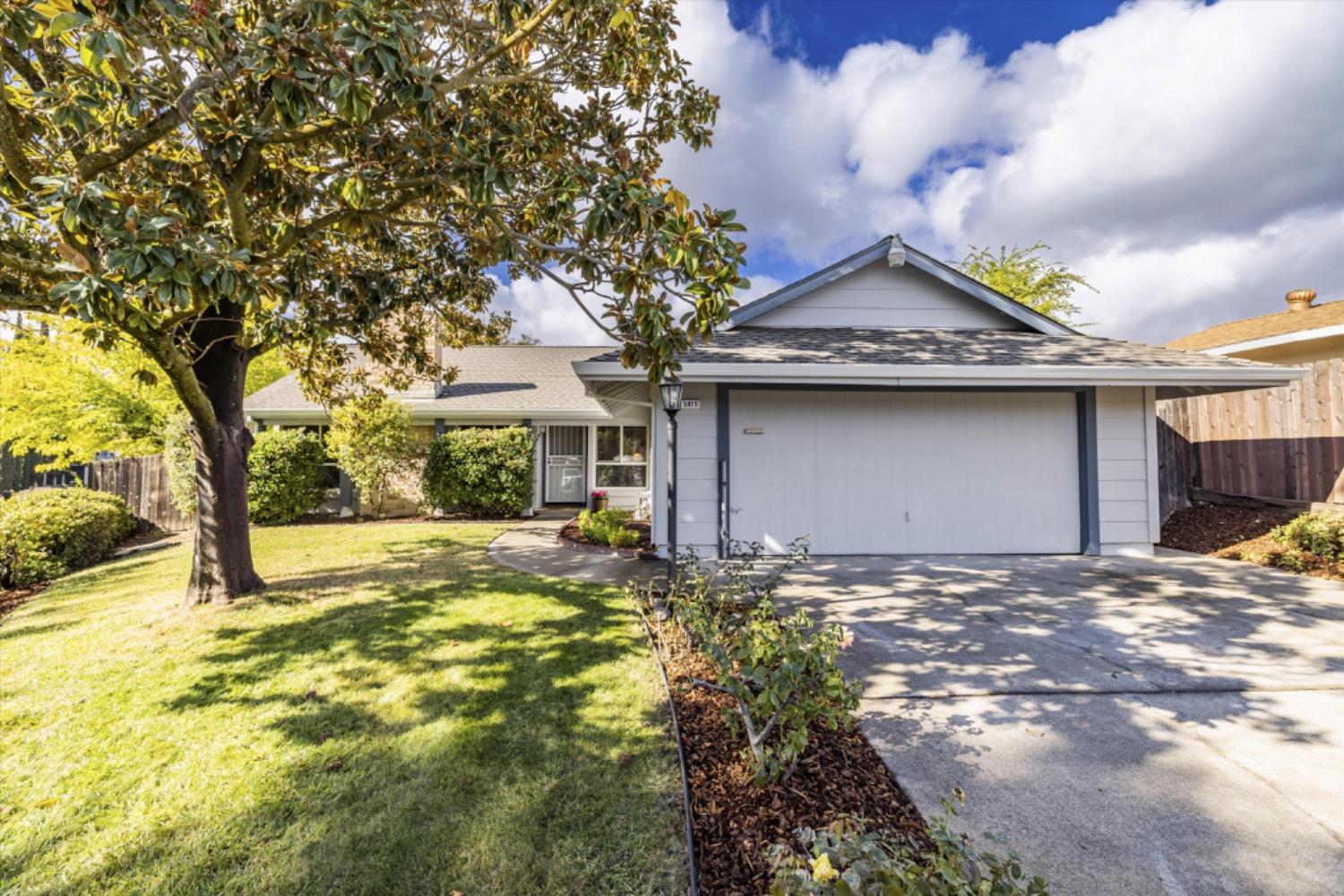 a view of a house with a yard and garage