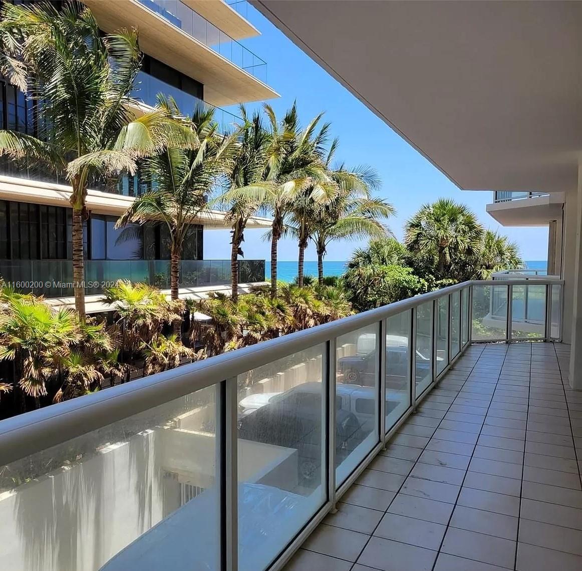 a view of a balcony with flower plants