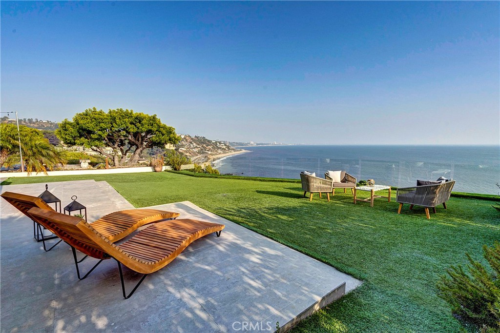 an outdoor sitting area with chairs and fire pit