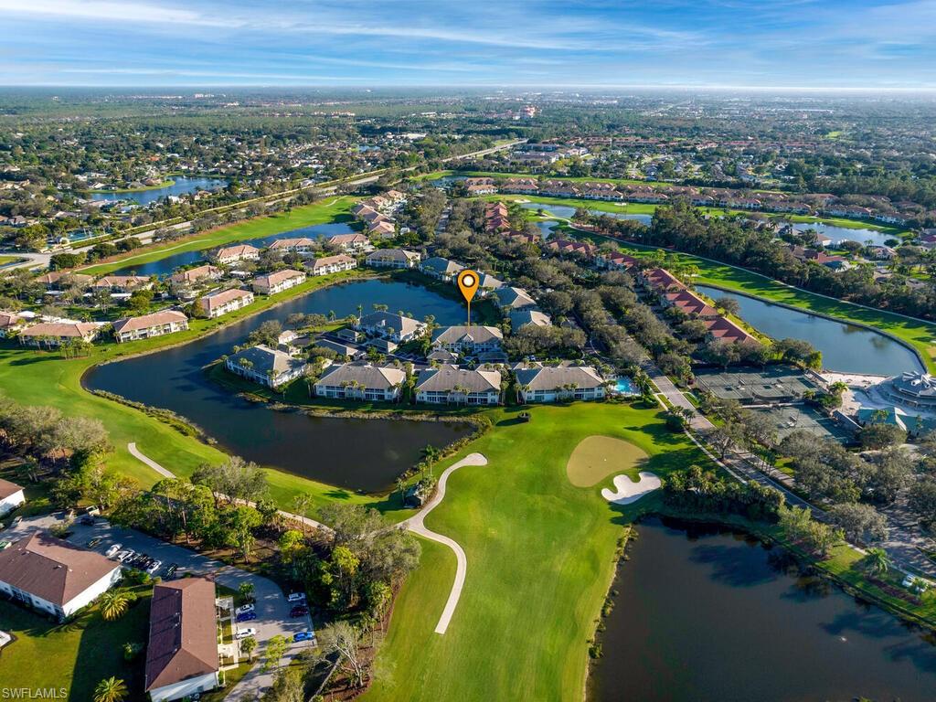 an aerial view of residential houses with outdoor space and swimming pool