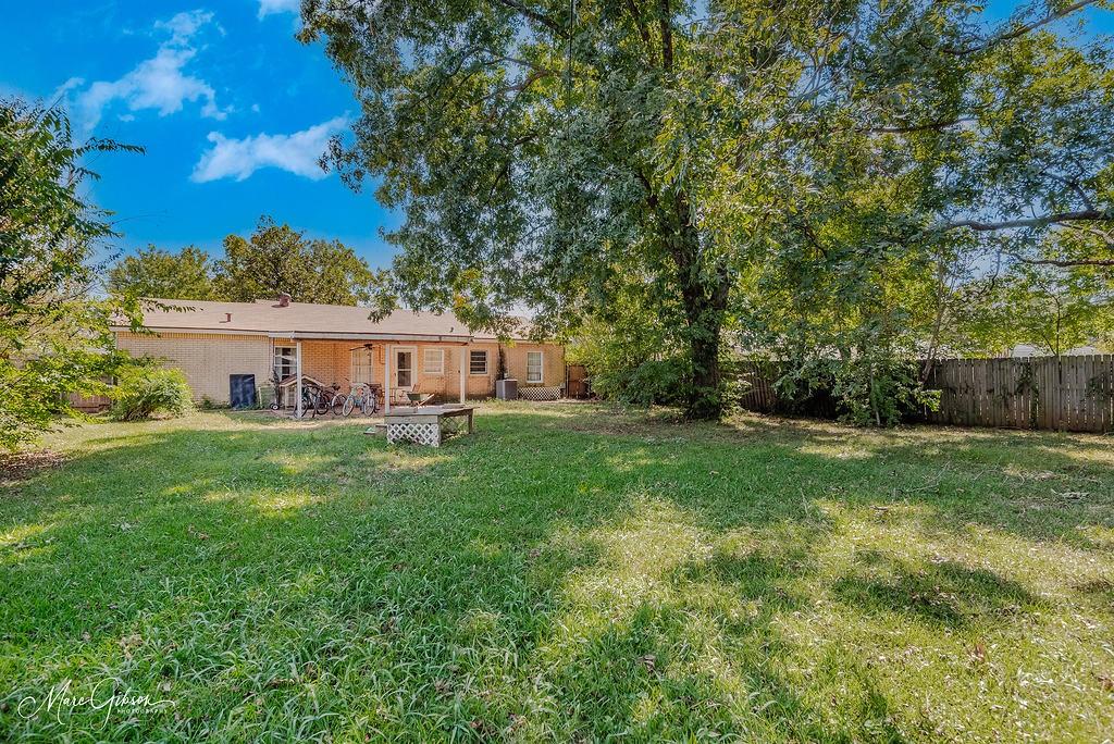 a front view of a house with yard and green space