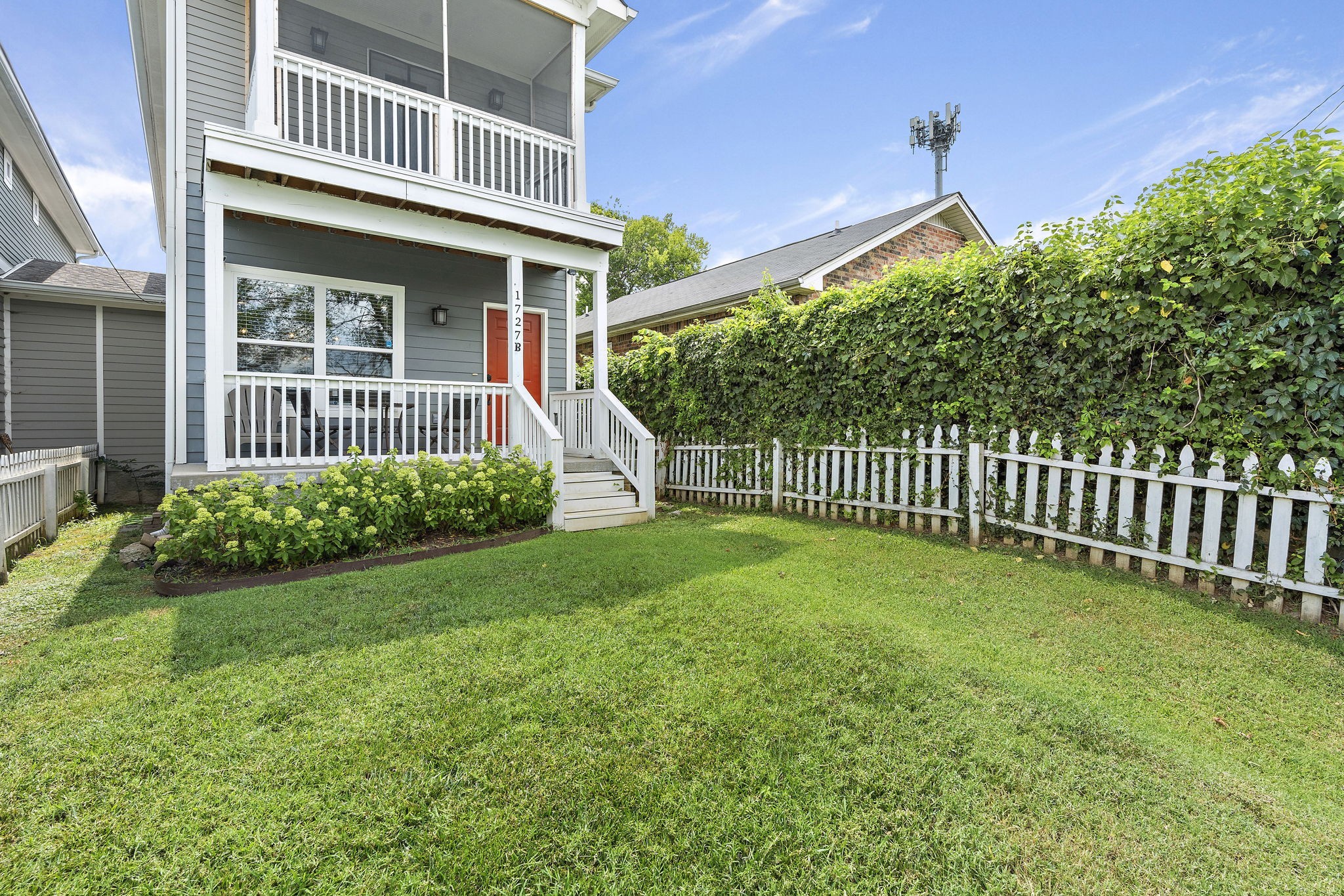 a view of a house with a yard and deck