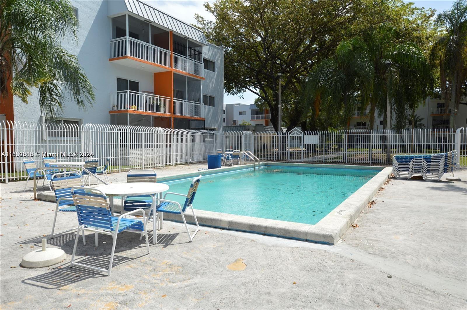 a swimming pool with outdoor seating and yard