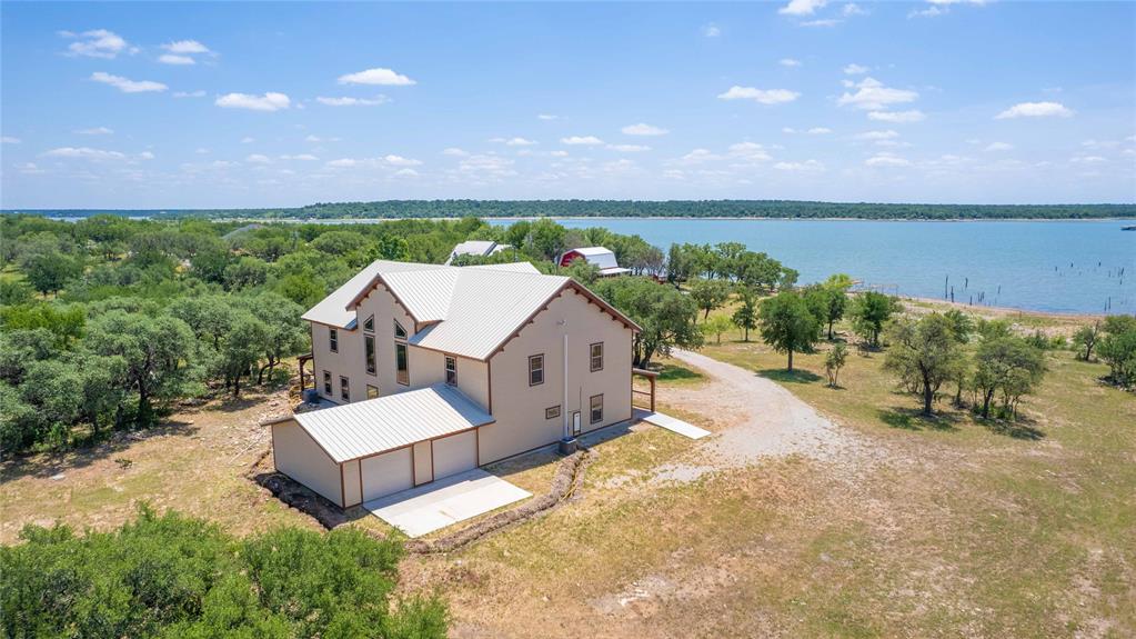 an aerial view of a house with a garden and lake view