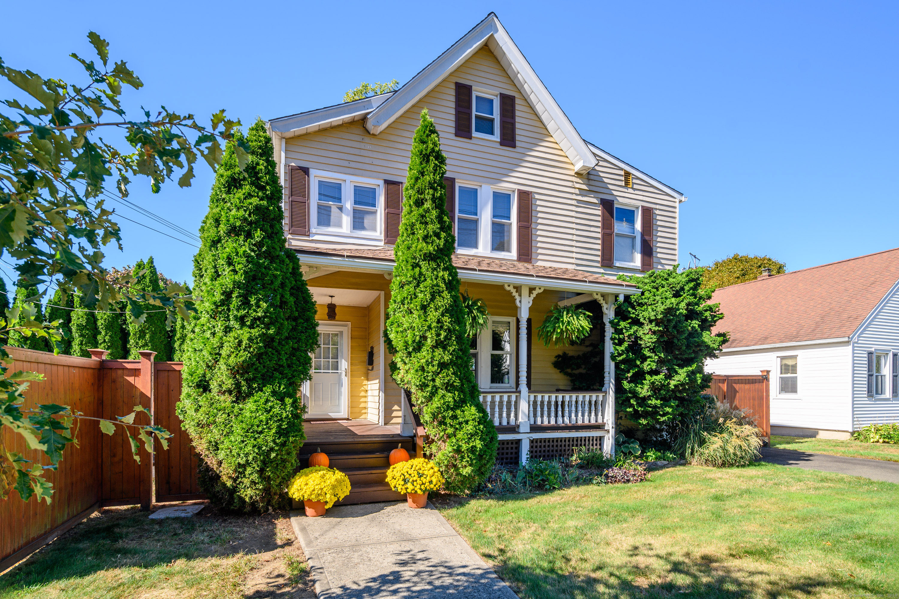 a front view of a house with a garden and porch