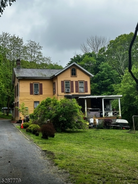 a front view of house with a garden