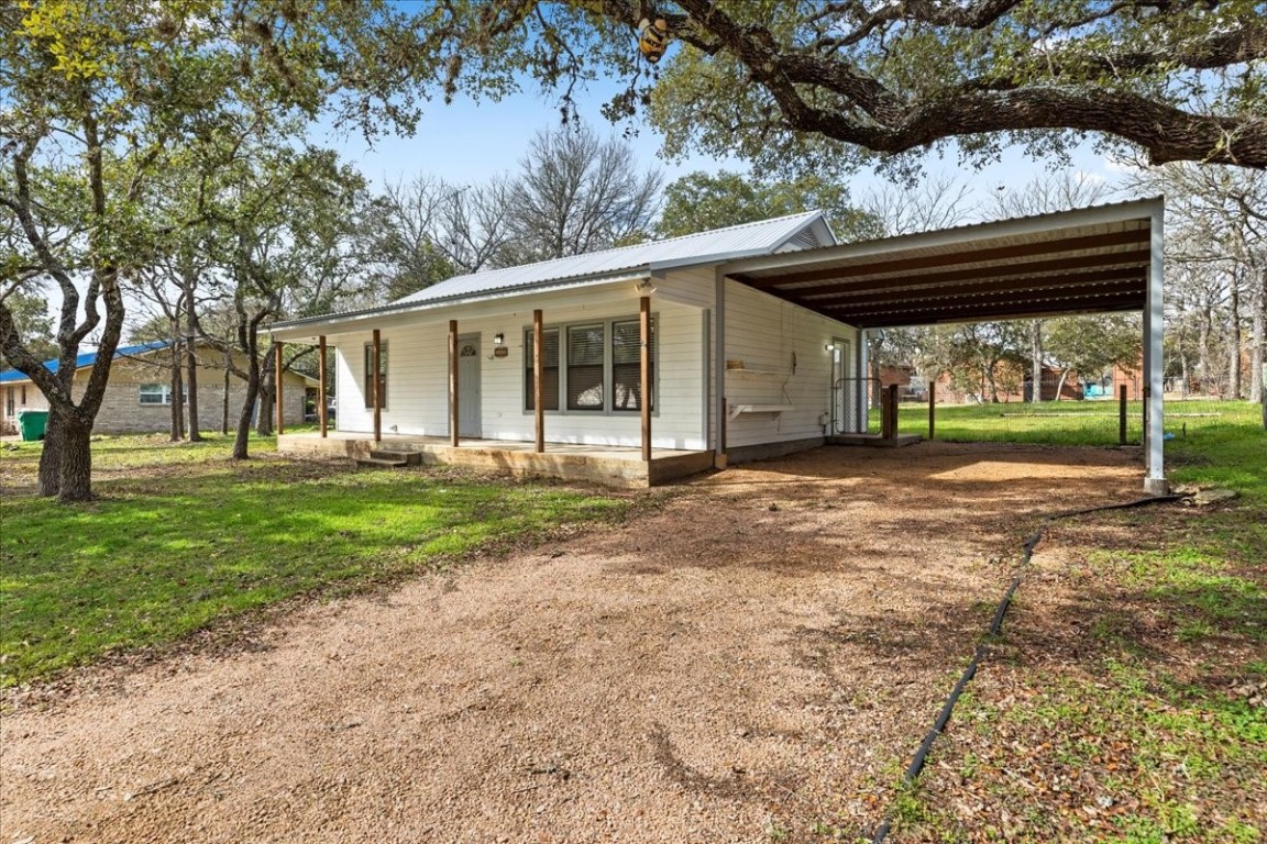 a view of a house with yard and tree s