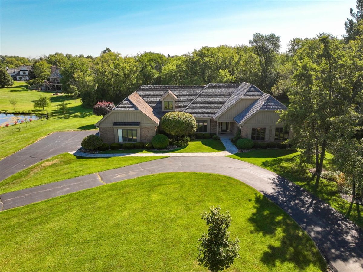 a view of house with swimming pool and yard