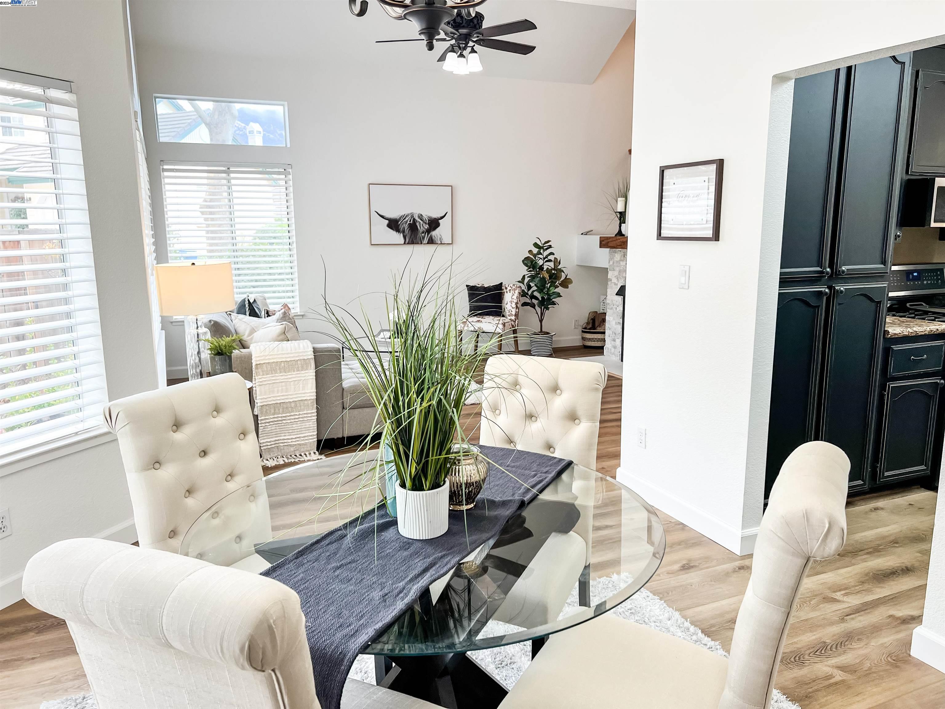 a living room with furniture flowerpot and wooden floor