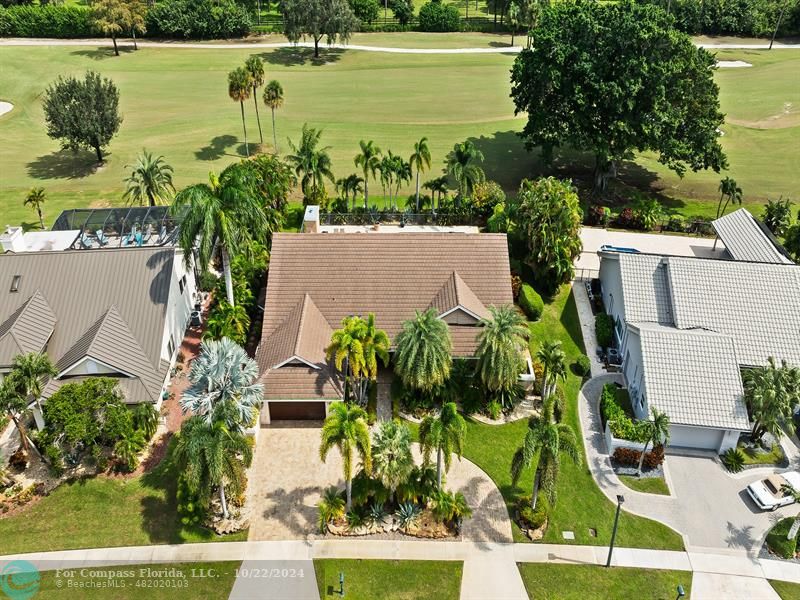 an aerial view of a house with a yard and lake view