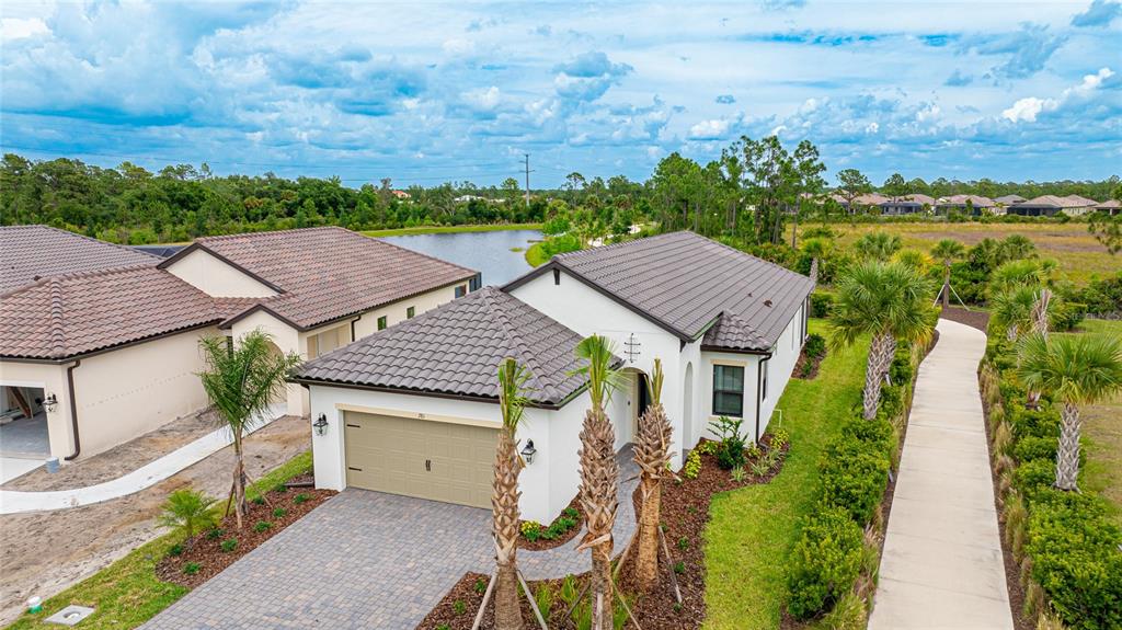 an aerial view of house with yard and mountain view in back