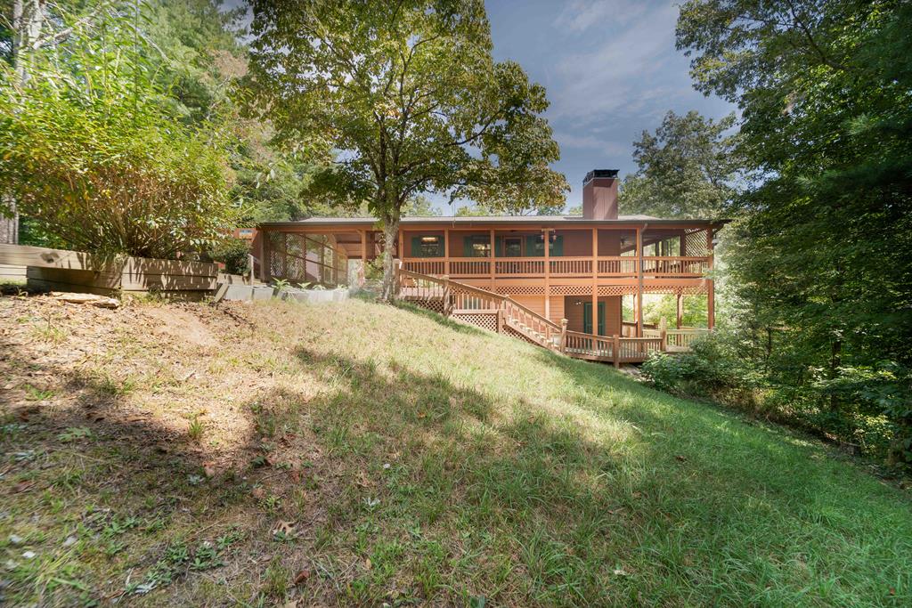 a view of a house with a yard and sitting area