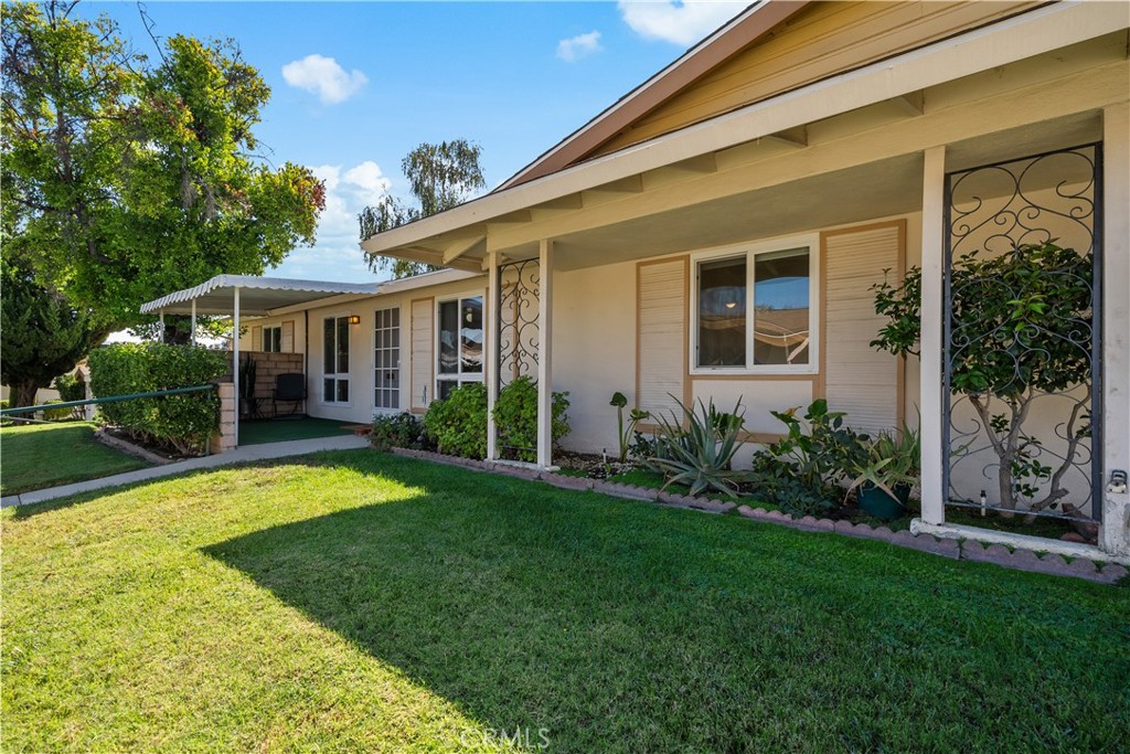 a view of a house with a yard patio and a small yard