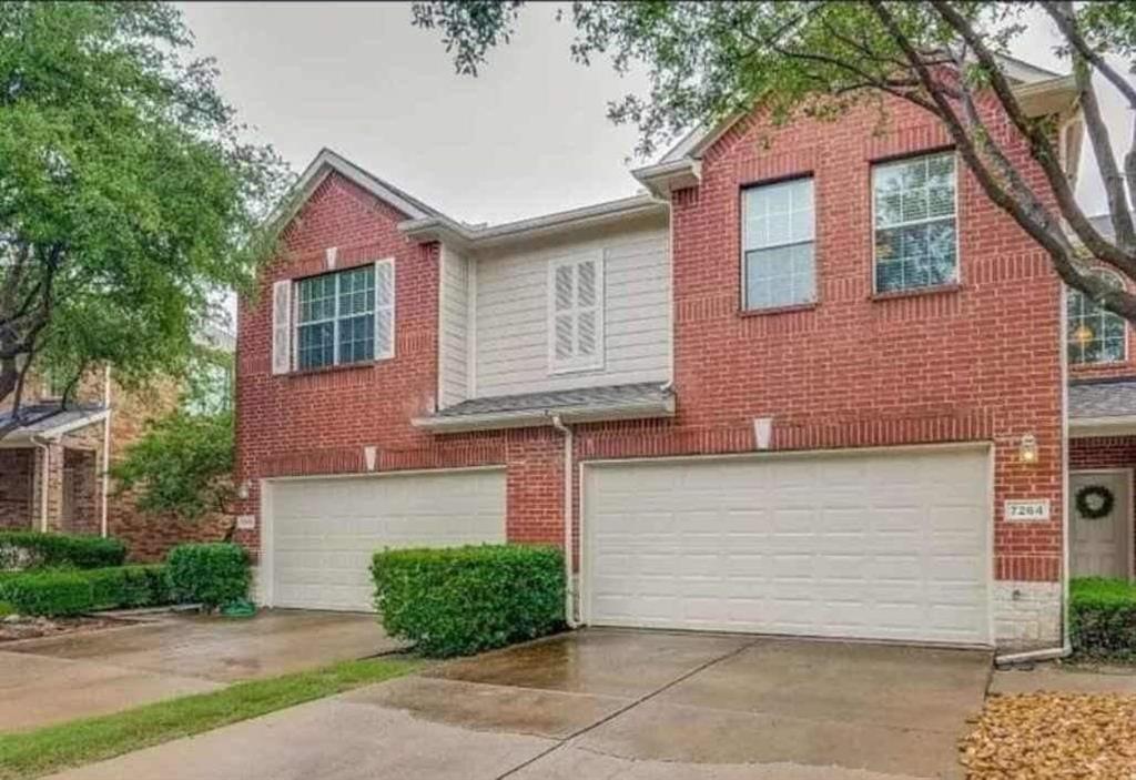 a front view of a house with garage