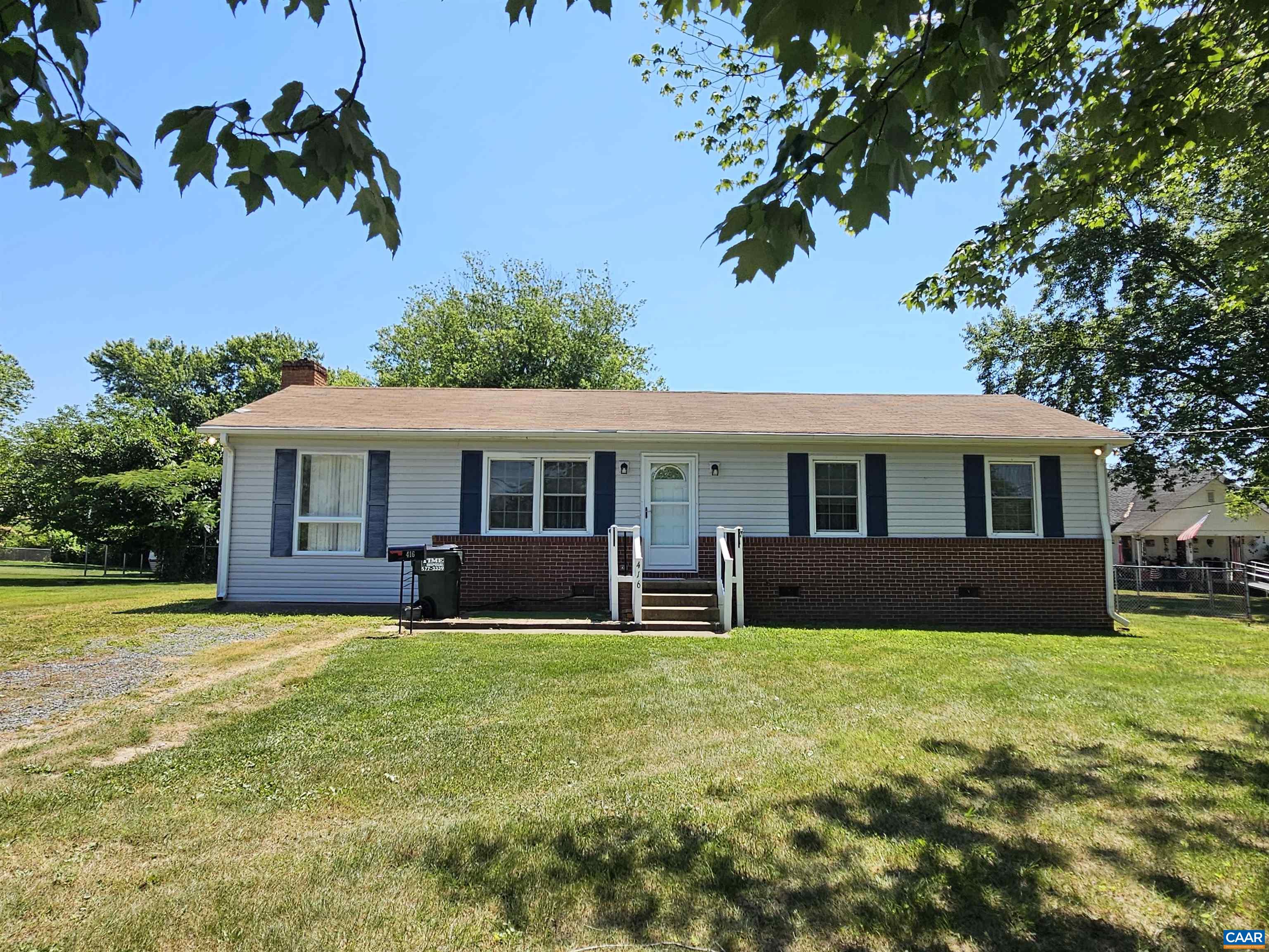 a view of a house with a yard and sitting area