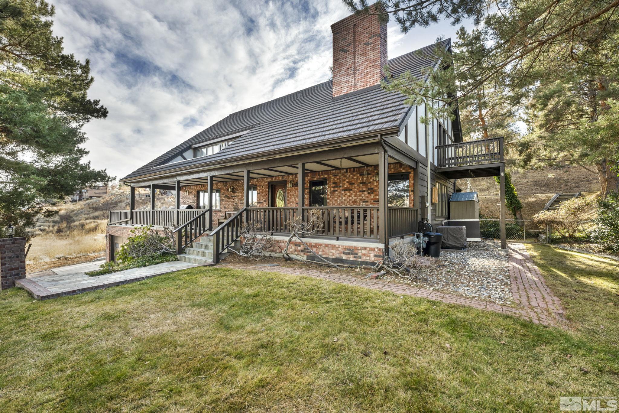 a view of a house with a patio and a yard